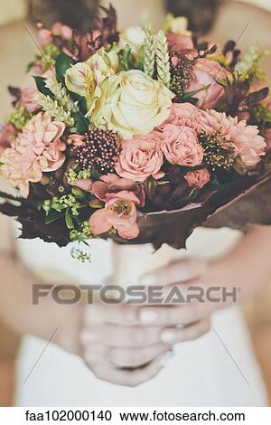 "Bride holding bouquet, cropped" View Large Photo Image Stock Image - "Bride holding bouquet, cropped". Fotosearch