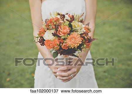 Stock Photo - "Bride holding bouquet, cropped". Fotosearch