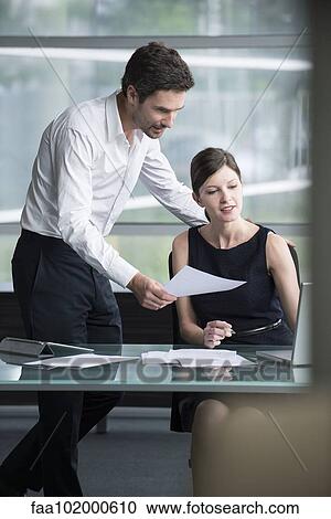 Stock Image - Business associates collaborating. Fotosearch