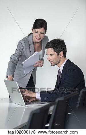 Stock Photo - Business associates collaborating. Fotosearch