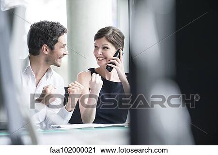 Business associates pleased by good news phone call View Large Photo Image Stock Image - Business associates pleased by good news phone call. Fotosearch