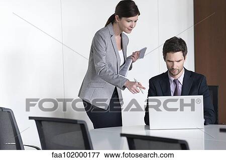 Business associates preparing for meeting View Large Photo Image Stock Photo - Business associates preparing for meeting. Fotosearch