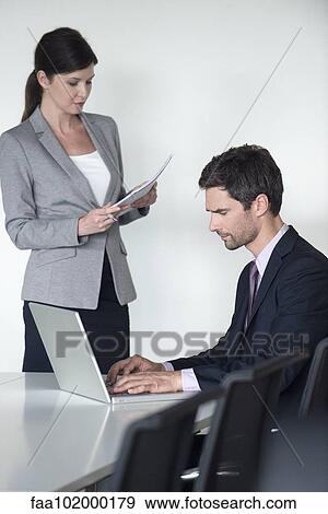 Business associates preparing for meeting View Large Photo Image Stock Photo - Business associates preparing for meeting. Fotosearch