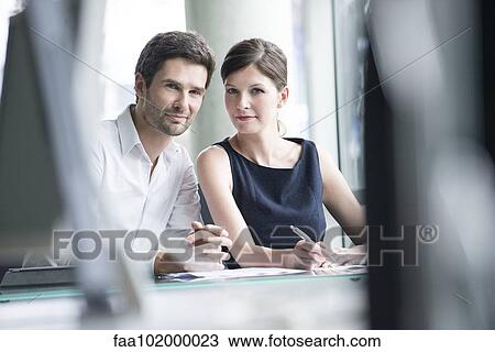 Business associates working closely together View Large Photo Image Stock Image - Business associates working closely together. Fotosearch