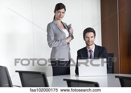 Business team members preparing for presentation View Large Photo Image Stock Photography - Business team members preparing for presentation. Fotosearch
