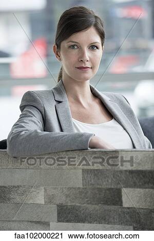 Business woman sitting in armchair View Large Photo Image Stock Image - Business woman sitting in armchair. Fotosearch
