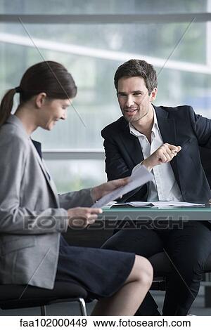 Stock Photo - Businessman explaining document to client. Fotosearch