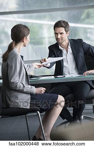 Businessman handing document to client View Large Photo Image Stock Photo - Businessman handing document to client. Fotosearch