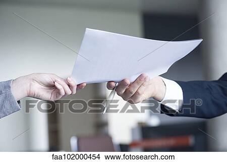 "Businessman handing document to colleague, cropped" View Large Photo Image Picture - "Businessman handing document to colleague, cropped". Fotosearch