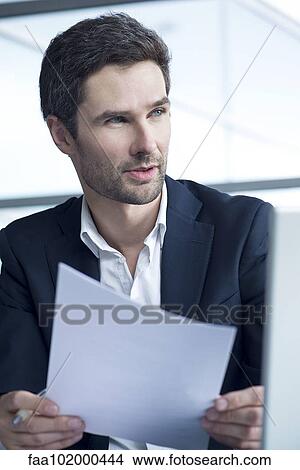 Picture - Businessman holding document. Fotosearch