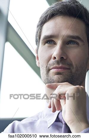 "Businessman looking up in thought, portrait" View Large Photo Image Stock Image - "Businessman looking up in thought, portrait". Fotosearch