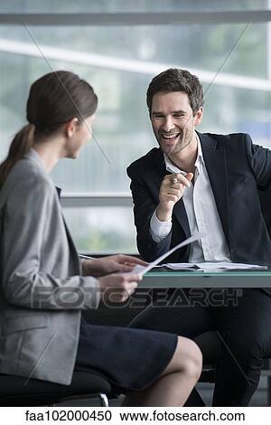Stock Image - Businessman man having lighthearted meeting with client. Fotosearch