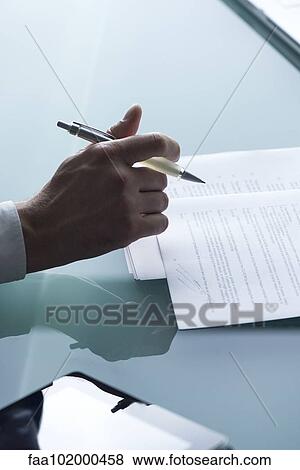 "Businessman reviewing document, cropped" View Large Photo Image Stock Photo - "Businessman reviewing document, cropped". Fotosearch