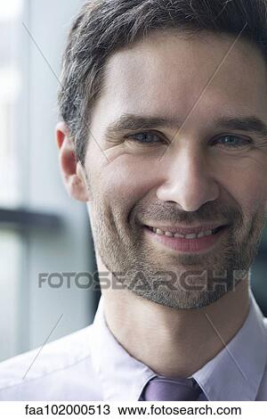 Stock Image - "Businessman smiling cheerfully, portrait". Fotosearch