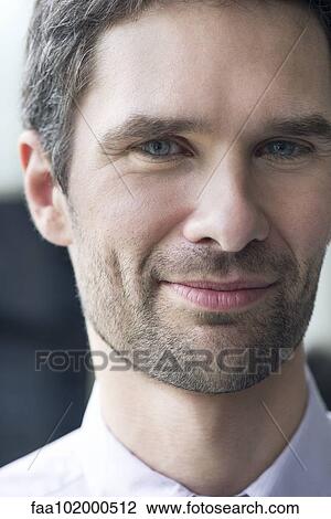 Stock Image - "Businessman smiling, portrait". Fotosearch