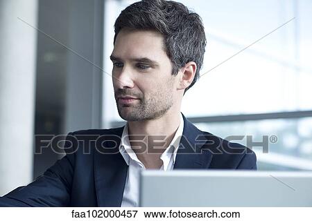 Stock Photo - Businessman working in office. Fotosearch