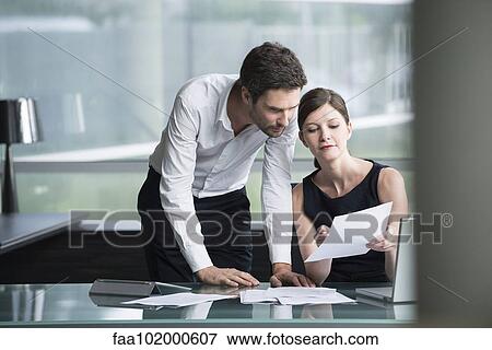 Businesswoman explaining document to associate View Large Photo Image Stock Photo - Businesswoman explaining document to associate. Fotosearch