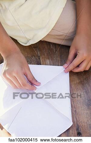 "Child folding paper, cropped" View Large Photo Image Stock Photography - "Child folding paper, cropped". Fotosearch