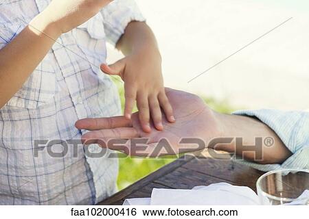 "Child touching adult's hand, cropped" View Large Photo Image Stock Photograph - "Child touching adult's hand, cropped". Fotosearch