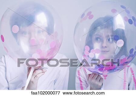 Children hiding behind transparent balloons View Large Photo Image Stock Photo - Children hiding behind transparent balloons. Fotosearch
