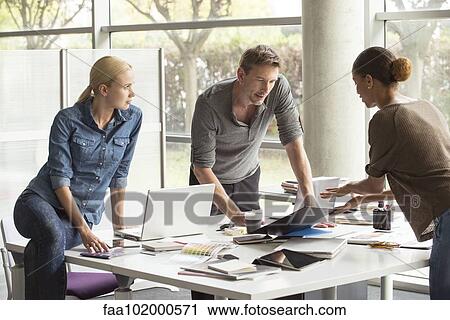Colleagues collaborating on project View Large Photo Image Stock Image - Colleagues collaborating on project. Fotosearch