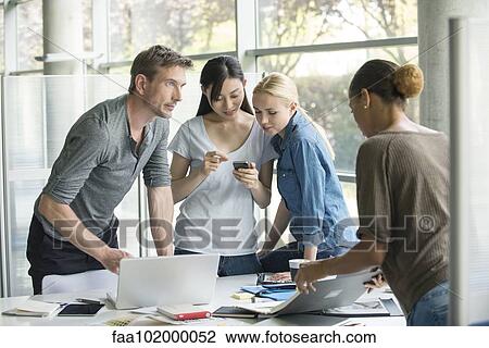Colleagues collaborating View Large Photo Image Stock Image - Colleagues collaborating. Fotosearch