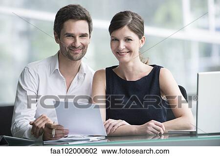 Colleagues reviewing document together View Large Photo Image Stock Image - Colleagues reviewing document together. Fotosearch
