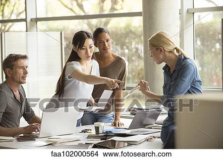 Colleagues sharing ideas View Large Photo Image Picture - Colleagues sharing ideas. Fotosearch
