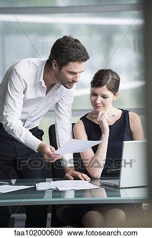 Colleagues working together in office View Large Photo Image Stock Photo - Colleagues working together in office. Fotosearch