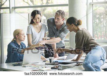 Colleagues working together on project View Large Photo Image Stock Photograph - Colleagues working together on project. Fotosearch