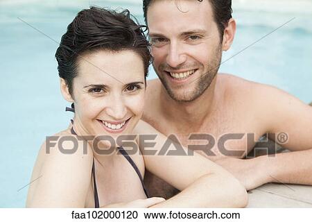 "Couple relaxing together in pool, portrait" View Large Photo Image Stock Image - "Couple relaxing together in pool, portrait". Fotosearch