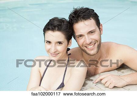 "Couple relaxing together in pool, portrait" View Large Photo Image Stock Photo - "Couple relaxing together in pool, portrait". Fotosearch