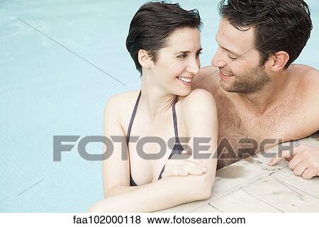 Stock Photo - Couple relaxing together in pool. Fotosearch
