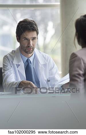 Stock Photography - Doctor explaining concerning results to patient. Fotosearch