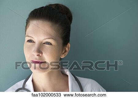 Stock Image - "Doctor looking away in thought, portrait". Fotosearch