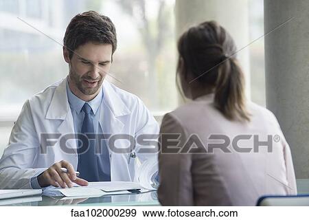 Doctor meeting with patient in office View Large Photo Image Stock Photo - Doctor meeting with patient in office. Fotosearch