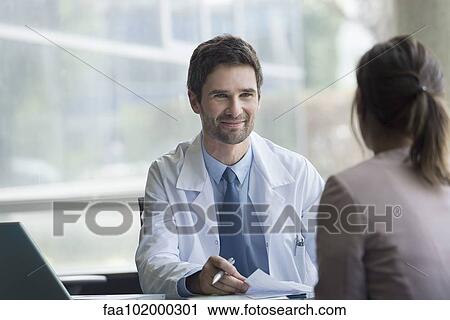 Doctor meeting with patient View Large Photo Image Stock Image - Doctor meeting with patient. Fotosearch