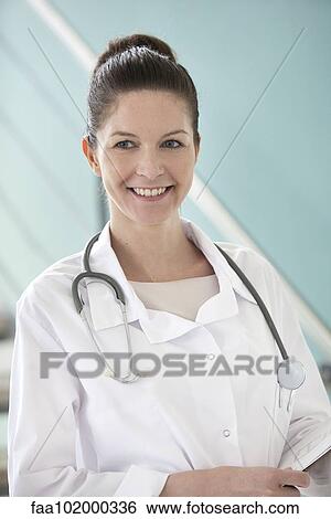 Stock Photograph - "Doctor smiling cheerfully, portrait". Fotosearch