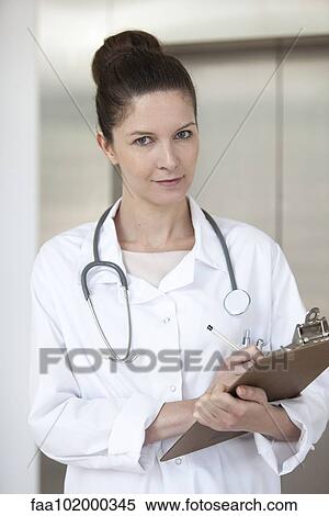 "Doctor writing on medical chart, portrait" View Large Photo Image Stock Photography - "Doctor writing on medical chart, portrait". Fotosearch