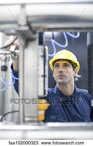 Engineer at work in industrial plant View Large Photo Image Stock Image - Engineer at work in industrial plant. Fotosearch