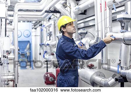 Engineer working in industrial plant View Large Photo Image Stock Photograph - Engineer working in industrial plant. Fotosearch