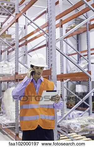 Engineer working in warehouse View Large Photo Image Stock Photo - Engineer working in warehouse. Fotosearch
