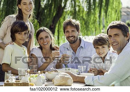 Family enjoying breakfast together outdoors View Large Photo Image Stock Image - Family enjoying breakfast together outdoors. Fotosearch