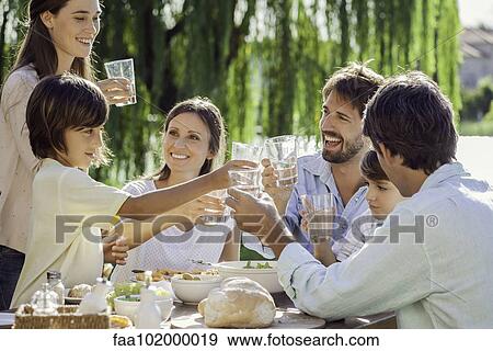 Family enjoying breakfast together outdoors View Large Photo Image Stock Photo - Family enjoying breakfast together outdoors. Fotosearch