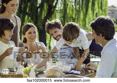 Family enjoying breakfast together outdoors View Large Photo Image Stock Photography - Family enjoying breakfast together outdoors. Fotosearch
