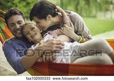 Stock Image - Family having fun together at home on the weekend. Fotosearch