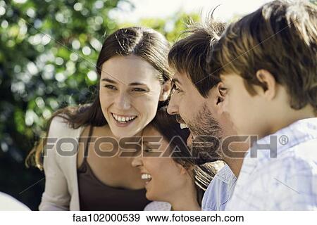 Family laughing together outdoors View Large Photo Image Stock Photo - Family laughing together outdoors. Fotosearch