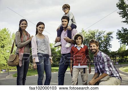 Stock Image - Family posing for group portrait outdoors. Fotosearch