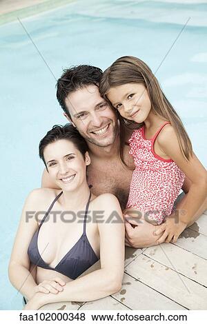 "Family relaxing together in pool, portrait" View Large Photo Image Stock Photo - "Family relaxing together in pool, portrait". Fotosearch