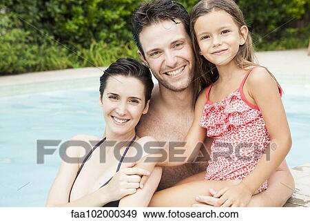"Family relaxing together in pool, portrait" View Large Photo Image Stock Photo - "Family relaxing together in pool, portrait". Fotosearch